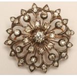 A VICTORIAN DIAMOND BROOCH/PENDANT, the central old mine cut stone of approximately 0.30cts within a