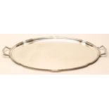 AN ART DECO SILVER TRAY, maker's mark FC, Sheffield 1933, of lobed oval form with two angular