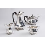 AN EDWARDIAN ARTS AND CRAFTS SILVER FOUR PIECE TEA SERVICE, maker C C Pilling, London 1903, of swept