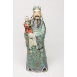 A LARGE CHINESE PORCELAIN FIGURE, modelled as a man with horse hair beard and moustache, wearing a