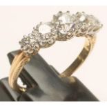 A FIVE STONE STONE DIAMOND RING, the central brilliant cut stone of approximately 0.50cts, flanked