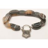 A MID VICTORIAN BANDED AGATE BRACELET, comprising six pairs of polished arched panels tied by five