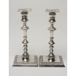 A PAIR OF SILVER CANDLESTICKS, makers Thomas Bradbury & Son, Sheffield 1931, the detachable square