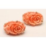 A PAIR OF ART DECO CORAL EARRINGS, the oval panels carved with roses to 18kt gold screw back