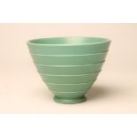 KEITH MURRAY FOR WEDGWOOD, a green glazed earthenware bowl of ribbed flared cylindrical form,