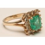 AN EMERALD AND DIAMOND SQUARE CLUSTER RING, the princess cut emerald claw set to a border of