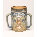 A DOULTON LAMBETH STONEWARE TYG, c.1900, of plain cylindrical form with three strapwork handles,