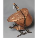 A VICTORIAN COPPER COAL SCUTTLE of helmet form raised on an open scroll work, wrought iron
