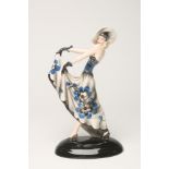 AN ART DECO DAKON GOLDSCHEIDER EARTHENWARE FIGURE of a young lady wearing a wide brimmed hat, blue