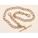 A 15CT GOLD CURB LINK ALBERT CHAIN with dog-clip fastener and bar, each piece and link stamped 15ct.