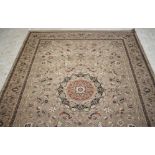 A PERSIAN STYLE RUG, modern, the champagne field with trailing flowers centred by a red roundel