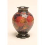 A MOORCROFT POTTERY VASE, early 20th century, of ovoid form with waisted neck on a swept foot,