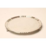 AN ART DECO SILVER SMALL SALVER, makers E. Barnard & Sons, London 1937, of shaped circular form with