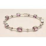 A PINK SAPPHIRE AND DIAMOND BRACELET, the seven various cut sapphires open back collet set to 18k