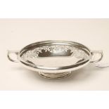 A SILVER SWEETMEAT DISH, makers Thomas Bradbury & Sons, Sheffield 1932, of shallow circular form