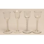 FOUR VARIOUS WINE GLASSES, three with round funnel bowls, one with a bell bowl, all issuing from