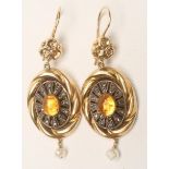 A PAIR OF 14CT GOLD DROP EARRINGS, the rope twist hollow panels centred by a cabochon polished