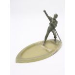 AN ART DECO FIGURAL CENTREPIECE, the green patinated cast metal young oarsman wearing an open necked
