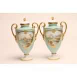 A PAIR OF MINTON CHINA VASES AND COVERS, 1920, of two handled ovoid form raised upon a low