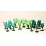 A SET OF SEVEN BRISTOL GREEN WINE GLASSES, the graduated honeycomb moulded plain "U" bowls issuing