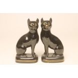 A PAIR OF VICTORIAN BLACK GLAZED STAFFORDSHIRE POTTERY CATS, modelled seated with free-standing