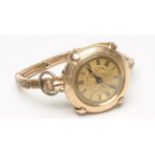 A LADY'S 14K GOLD TOP WIND FOB WATCH, the foliate engraved gilt dial with black painted Roman