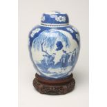 A CHINESE PORCELAIN JAR AND COVER, of ovoid form, painted in underglaze blue with two panels, one