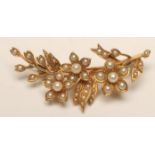 A LATE VICTORIAN GOLD FLOWER SPRAY BROOCH set with seed pearls, stamped 15ct (Est. plus 18%