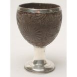 A GEORGIAN COCONUT CUP, the shell incise carved with rosettes with applied unmarked white metal rim,