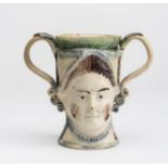 A ROYAL COMMEMORATIVE EARTHENWARE FROG LOVING CUP, c.1800, possibly Scottish, the double sided mug