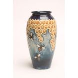 A MOORCROFT POTTERY VASE, modern, of rounded cylindrical form, tubelined and painted in shades of