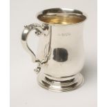 A GEORGIAN STYLE SILVER MUG, makers Barker Bros., Chester 1922, of plain baluster form engraved with