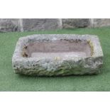 A SANDSTONE TROUGH of oblong form with mildly inward sloping sides, 30" x 18" x 9" (Est. plus 18%