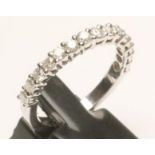 A DIAMOND HALF HOOF ETERNITY RING, the fifteen round brilliant cut stones claw set to a plain