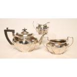 A SILVER THREE PIECE TEA SERVICE, makers Deakin & Deakin, Sheffield 1926, of lobed oval form,