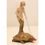 AN ART NOUVEAU ROYAL DUX BISQUE PORCELAIN FIGURE modelled as a naked maiden standing on the back
