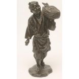 A JAPANESE BRONZE FIGURE, Meiji period, of a fisherman carrying a flat basket of fish on his left