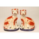 A PAIR OF VICTORIAN STAFFORDSHIRE POTTERY SPANIELS, well modelled with angular faces and a free