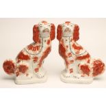 A PAIR OF VICTORIAN STAFFORDSHIRE POTTERY SPANIELS, well modelled, with tan markings, gilt collars