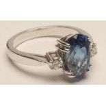 A THREE STONE SAPPHIRE AND DIAMOND RING, the "chequerboard" pear cut sapphire of 3.45cts, claw set