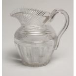 A GEORGIAN WATER JUG of baluster form with slice and strawberry cut panels below slice cut shoulders