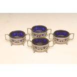 A SET OF FOUR FRENCH SILVER SALTS, c.1800, of oval form, cast and pierced with ribbon tied swags