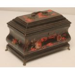 A GEORGIAN BLACK LACQUERED TEA CADDY, 18th century, of sarcophagus form painted with flowers and