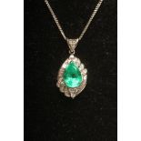 AN EMERALD AND DIAMOND PENDANT, the Colombian pear cut emerald claw set in platinum with baguette