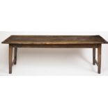 AN OAK FARMHOUSE TABLE, 19th century, the cleated three plank top on plain frieze, raised on four