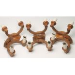 A SET OF SIX ADZED OAK WALL LIGHTS each crescent shaped support issuing a pair of sconces with