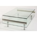 A CLEAR GLASS AND CHROME LOOP COFFEE TABLE, 1970's, raised on waisted turned supports, 52" x 27 1/2"
