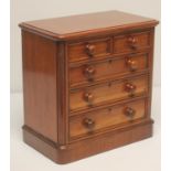 A VICTORIAN MAHOGANY MINIATURE CHEST of rounded oblong form, the moulded edged top over two short