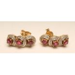 A PAIR OF RUBY AND DIAMOND STUD EARRINGS, the triple horseshoe clusters on 18ct gold posts, 3/4"