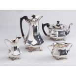 AN EDWARDIAN ARTS AND CRAFTS FOUR PIECE SILVER TEA SERVICE, maker C C Pilling, London 1903, of swept